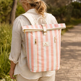 Woman wearing the Sunza Original cooler backpack in Sunset Blush, back view on an outdoor path
