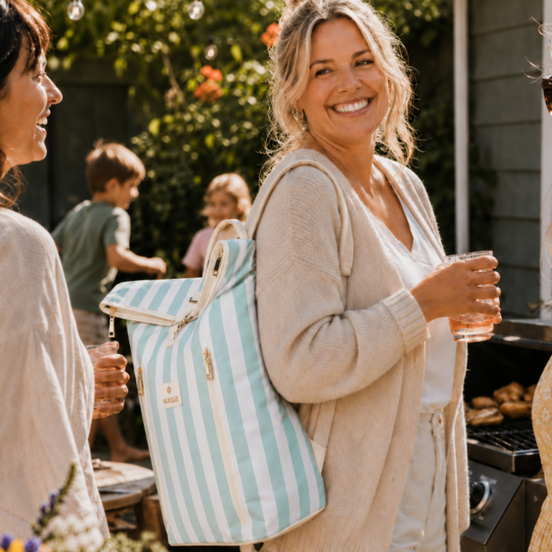 Woman carrying Sunza Original Cooler Backpack in Seafoam Mist at a backyard gathering — stylish insulated backpack for women Australia