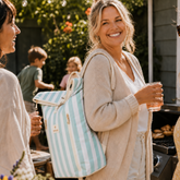 Woman carrying Sunza Original Cooler Backpack in Seafoam Mist at a backyard gathering — stylish insulated backpack for women Australia