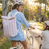 Mum wearing Sunza Original Cooler Backpack in Sunset Blush on a bike ride with her child — insulated cooler backpack for women Australia