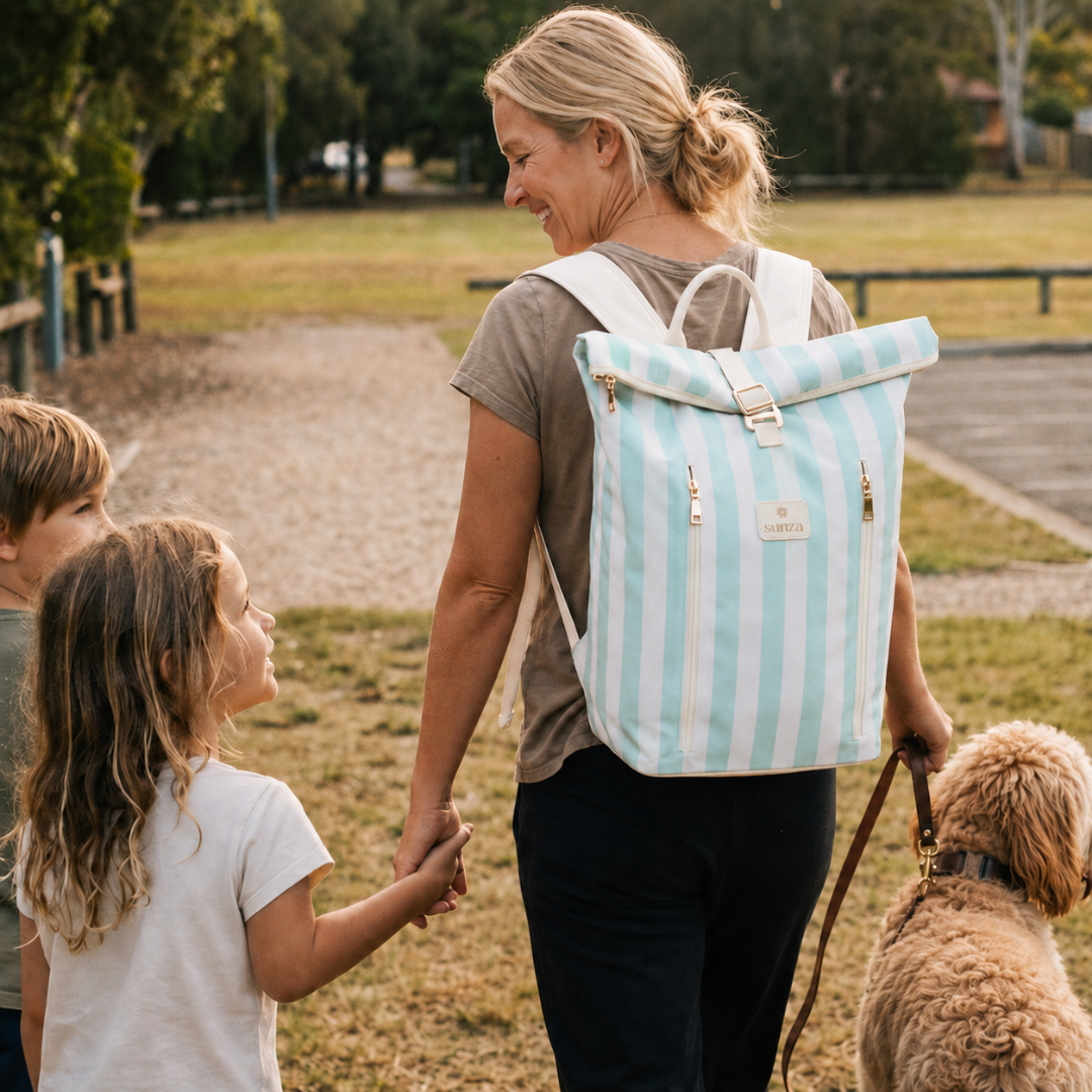 Mum wearing Sunza Original Cooler Backpack in Seafoam Mist while walking with her children and dog — cooler backpack for family days out Australia
