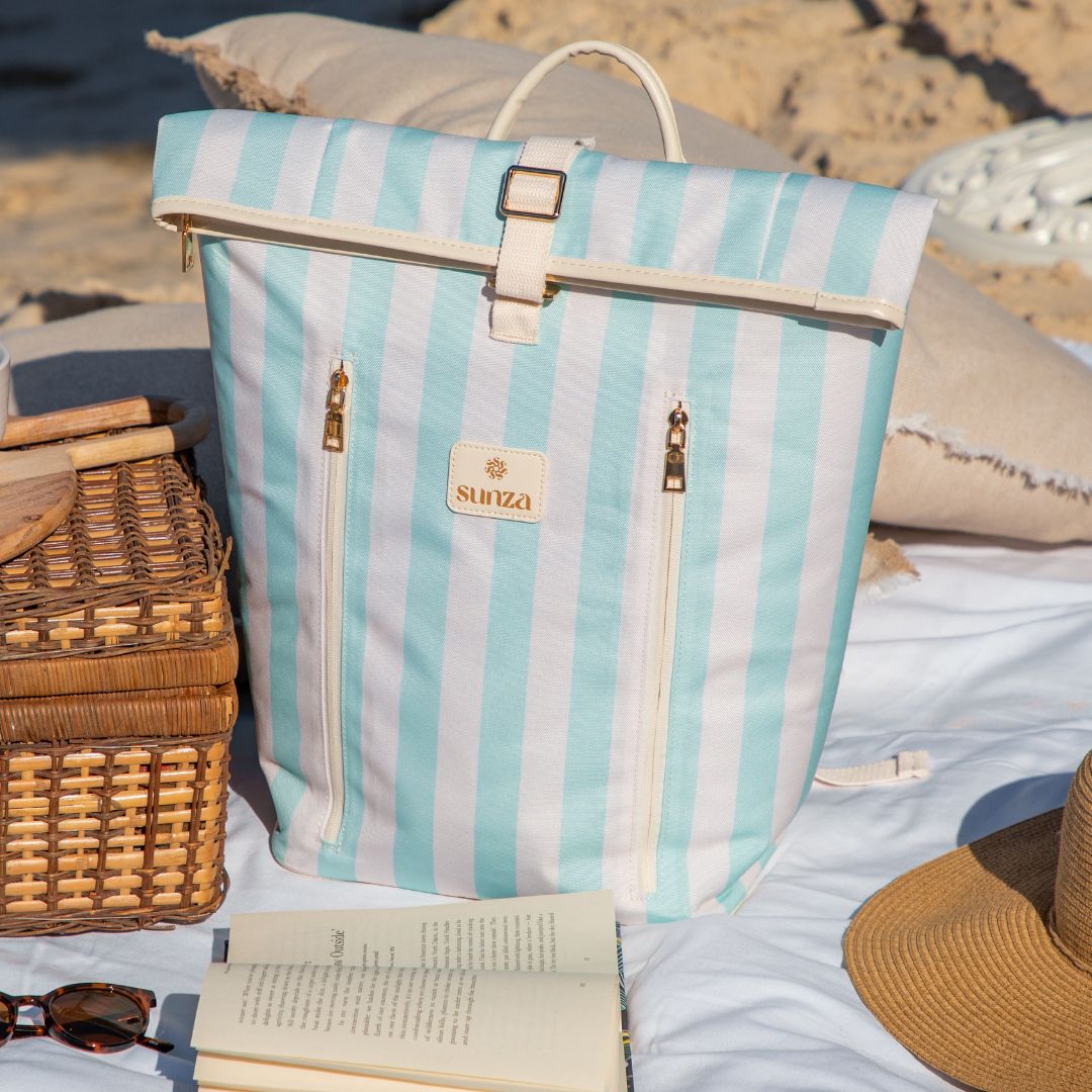 Sunza Original Cooler Backpack in Seafoam Mist at a beach picnic alongside a wicker basket — stylish insulated bag for beach days Australia